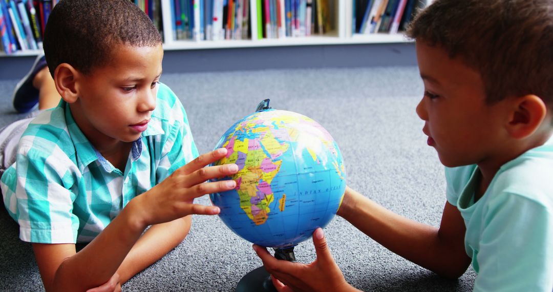 Two Young Boys Exploring Globe in Classroom Setting - Free Images, Stock Photos and Pictures on Pikwizard.com