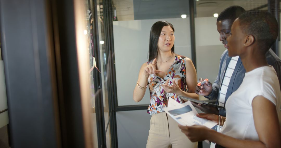 Diverse Team Collaborating in Modern Office Gathering Insights