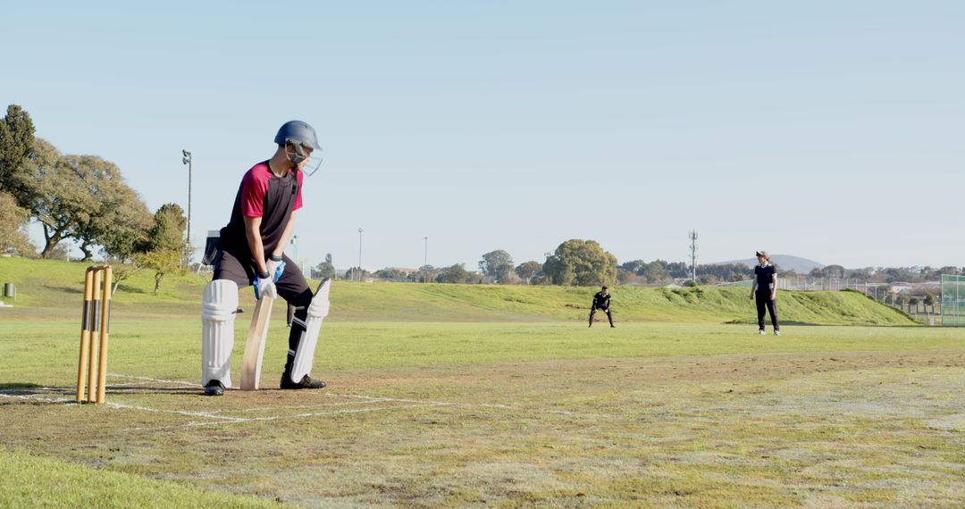 Cricketers Engaged in a Intense Match on Lush Green Field