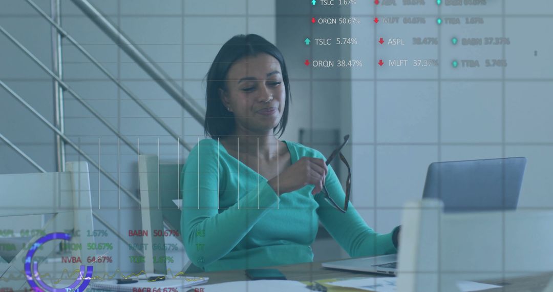 Confident Businesswoman Using Laptop with Financial Graphics Overlay
