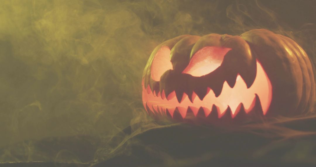 Glowing Jack-o'-Lantern with Fierce Carved Teeth and Swirling Fog for Halloween Ambience