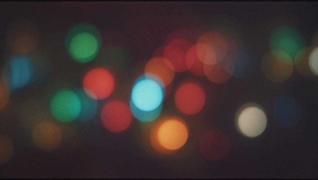 Glowing Colored Bokeh Circles Spreading Across Frame with Film Grain Night Ambience