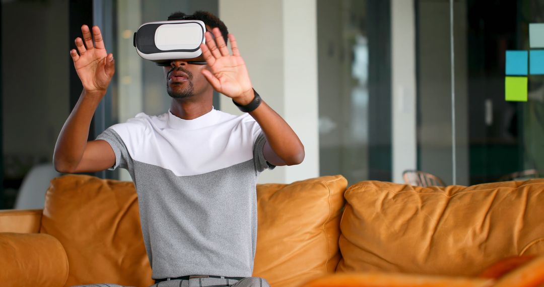 Young Man Experiencing Virtual Reality with VR Headset at Home - Free Images, Stock Photos and Pictures on Pikwizard.com