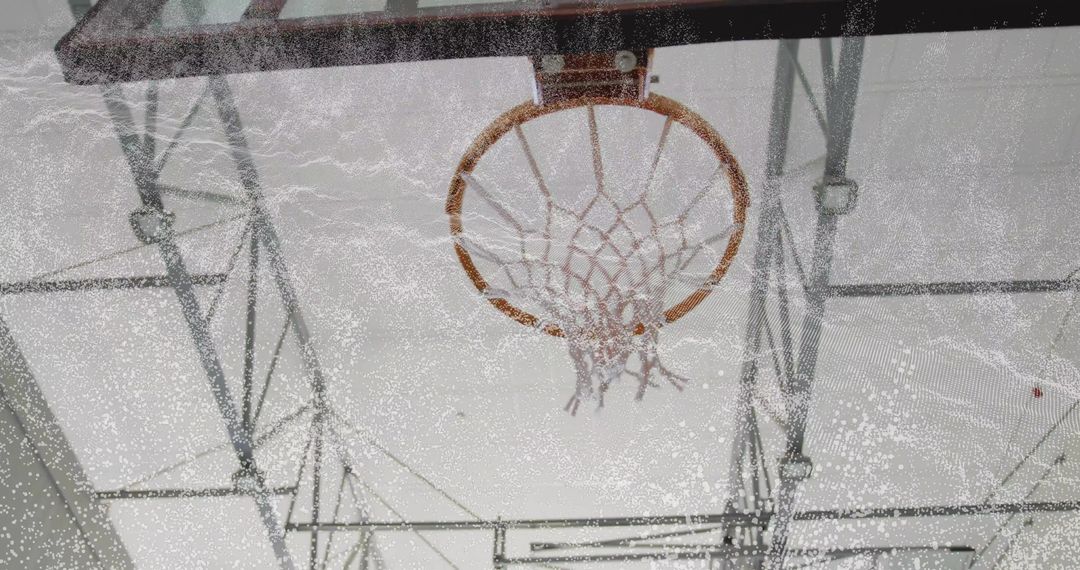 Vintage Basketball Hoop with Weathered Rim and Frayed Net in Gymnasium Atmosphere