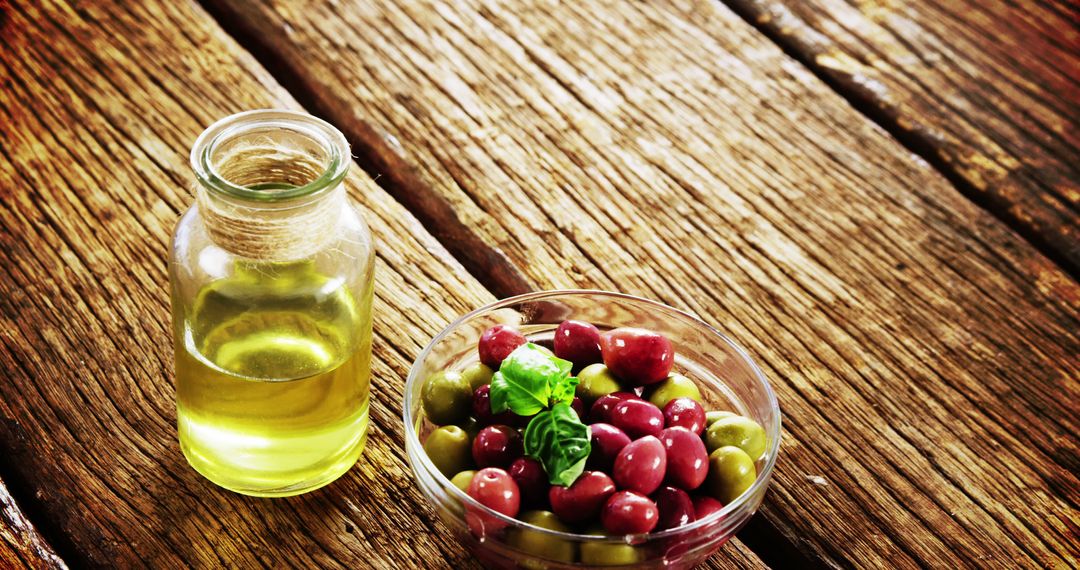 Healthy mediterranean olives with olive oil on rustic wooden table - Free Images, Stock Photos and Pictures on Pikwizard.com