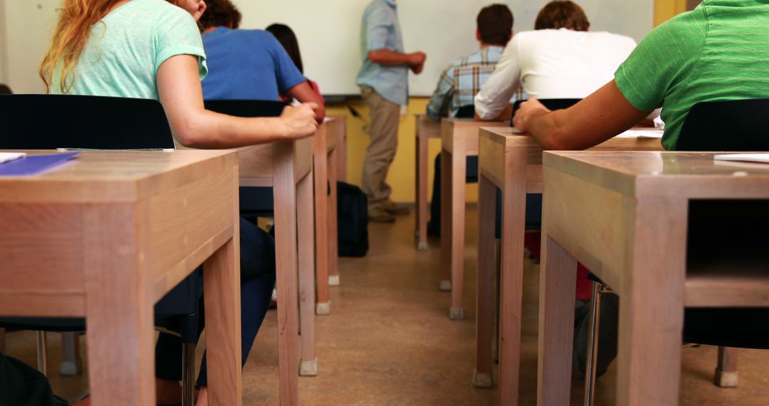 Students Sitting in Classroom Listening to Teacher's Lecture - Free Images, Stock Photos and Pictures on Pikwizard.com