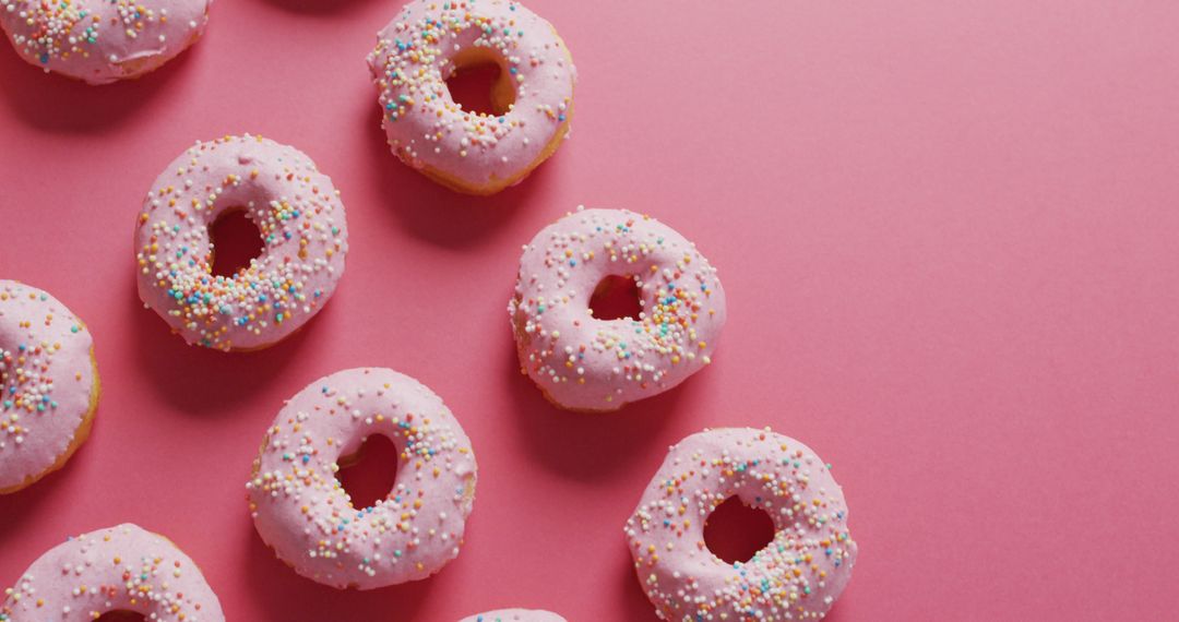 Image of donuts with icing on pink background - Free Images, Stock Photos and Pictures on Pikwizard.com