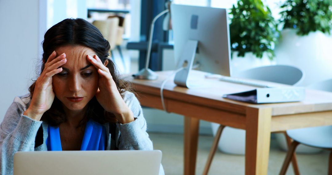 Stressed Woman Working on Laptop in Office - Free Images, Stock Photos and Pictures on Pikwizard.com