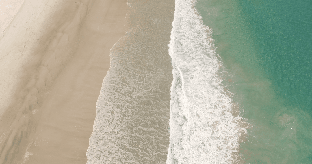 Transparent Waves Rushing to Sandy Shore
