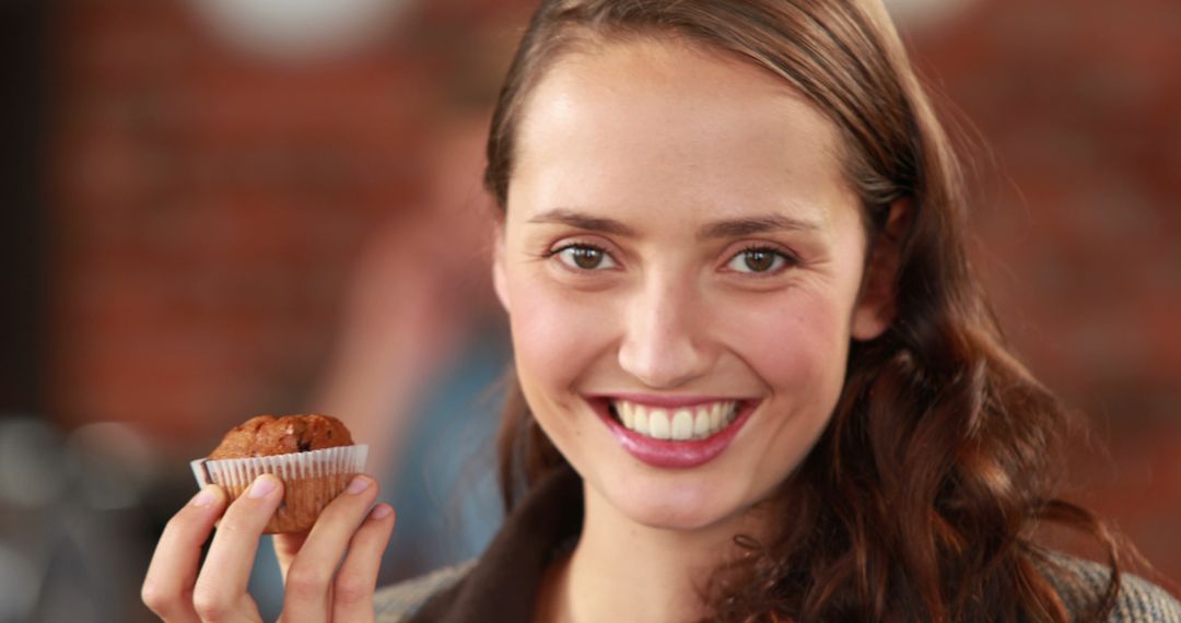 Smiling Woman Holding Homemade Muffin - Free Images, Stock Photos and Pictures on Pikwizard.com