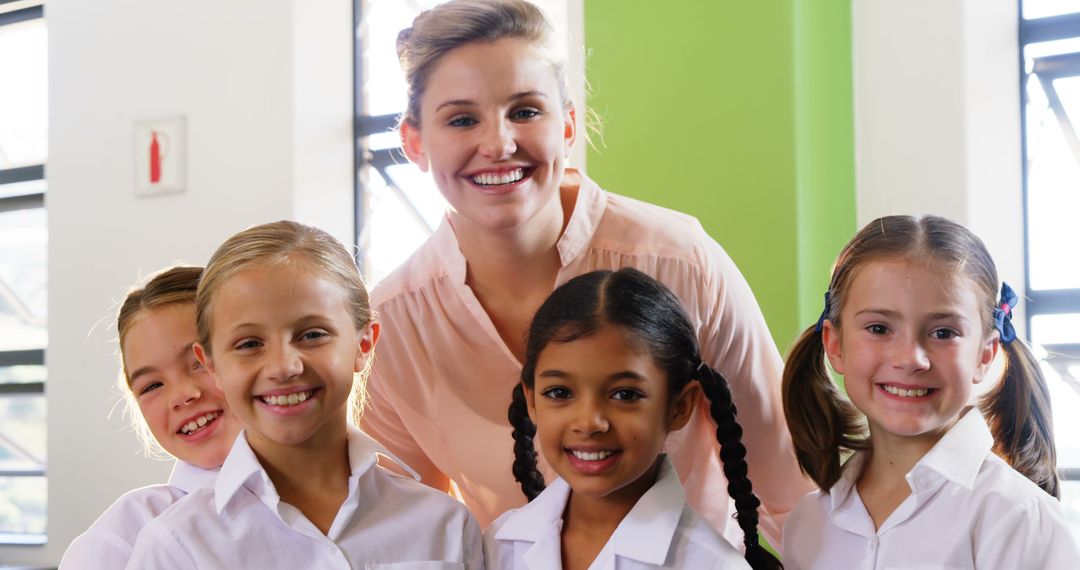 Teacher with Diverse Smiling Students in Classroom