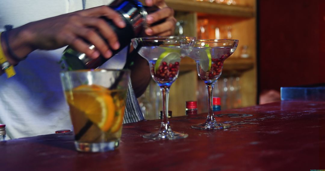 Bartender Preparing Colorful Cocktails on Wooden Bar Counter - Free Images, Stock Photos and Pictures on Pikwizard.com