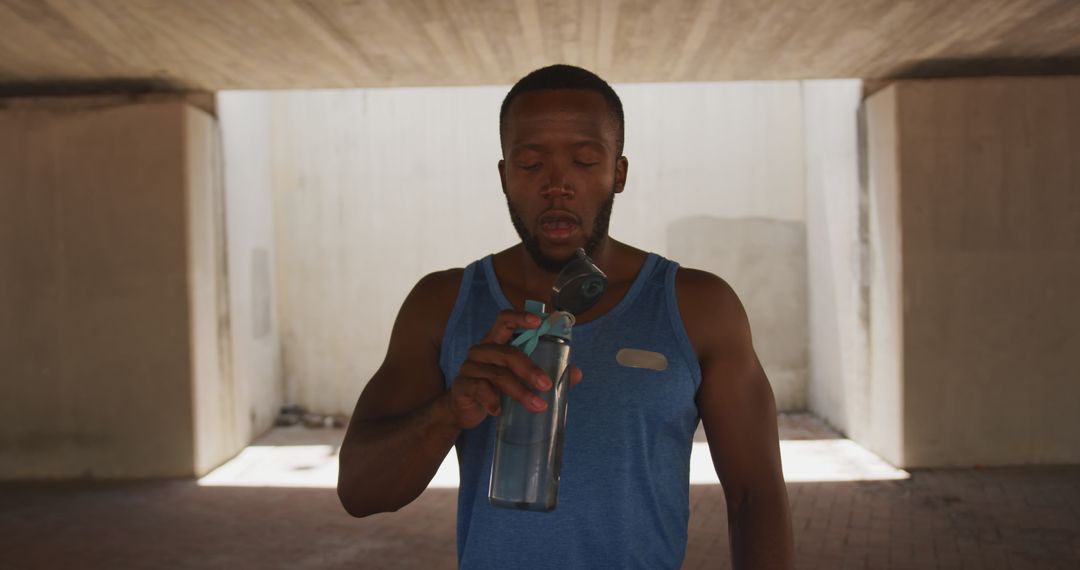 Male Athlete Hydrating Post Workout Under Bridge - Free Images, Stock Photos and Pictures on Pikwizard.com