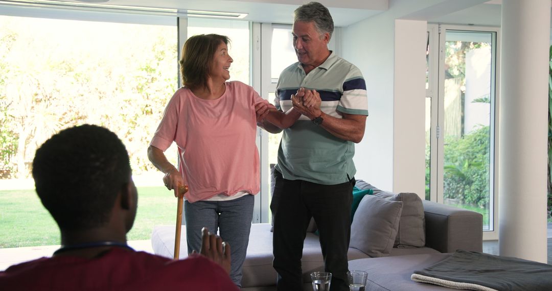 Senior Couple Enjoying Supportive Interaction at Home with Healthcare Professional