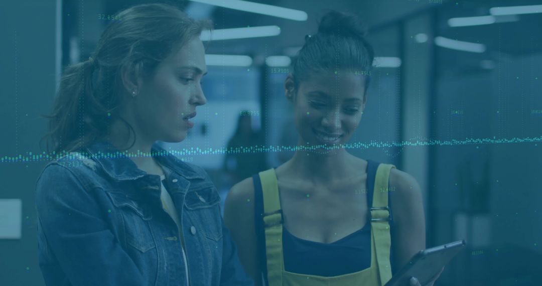 Coworkers collaborating over tablet with waveform overlay in modern office corridor