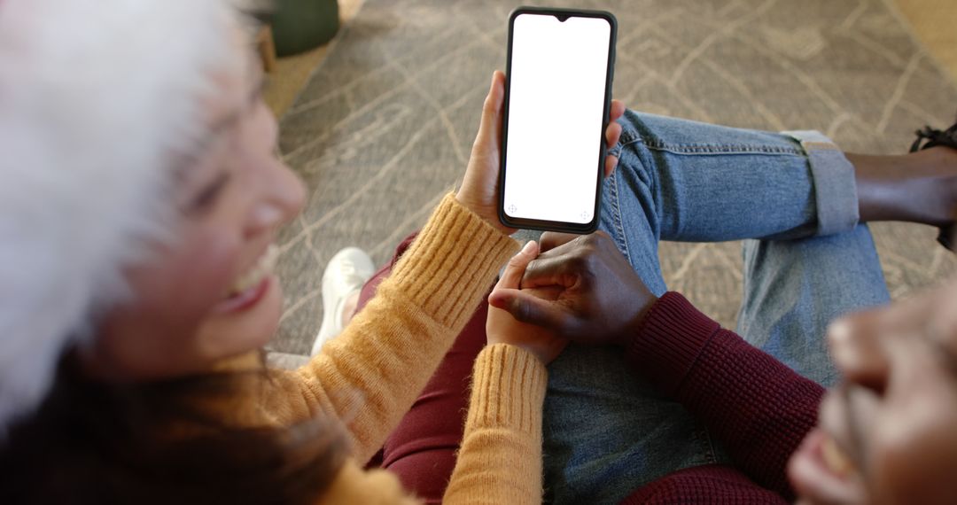 Couple Holding Hands Using Smartphone Indoors - Free Images, Stock Photos and Pictures on Pikwizard.com