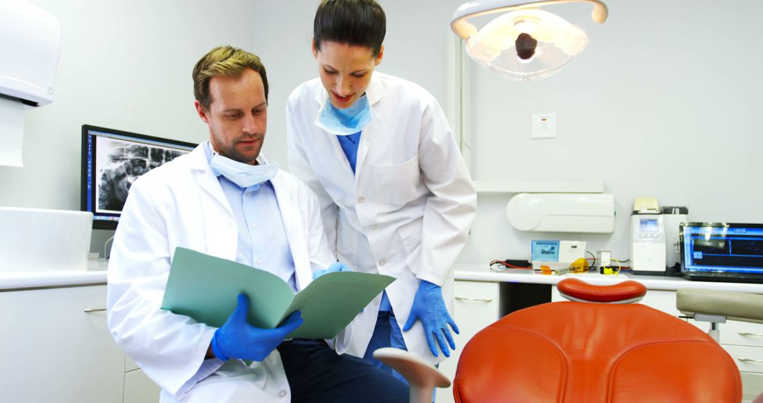 Dentists Reviewing Patient Records in Modern Dental Office - Free Images, Stock Photos and Pictures on Pikwizard.com