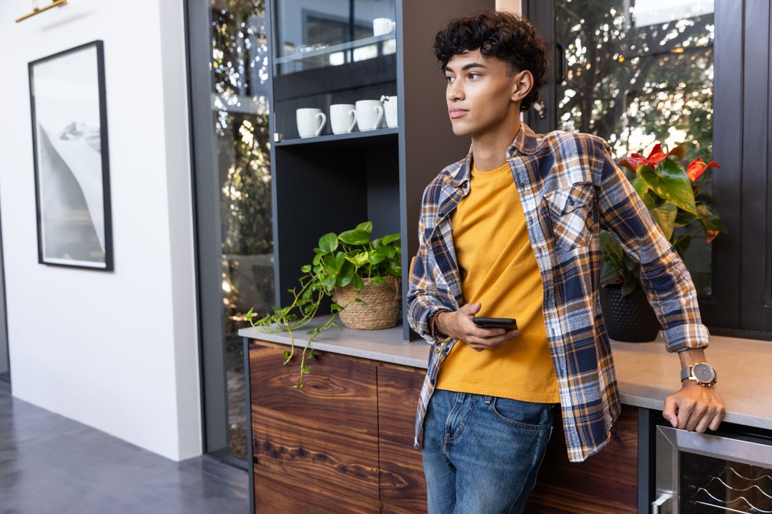 Asian Man Relaxing in a Stylish Lounge with Smartphone