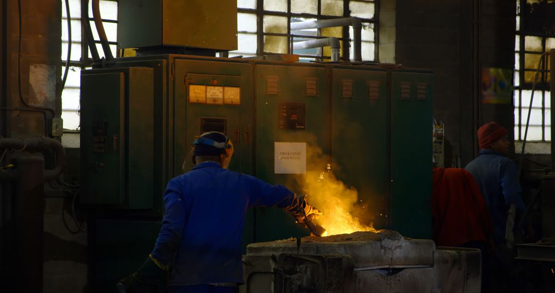 Industrial Worker Handling Hot Molten Metal in Factory - Free Images, Stock Photos and Pictures on Pikwizard.com