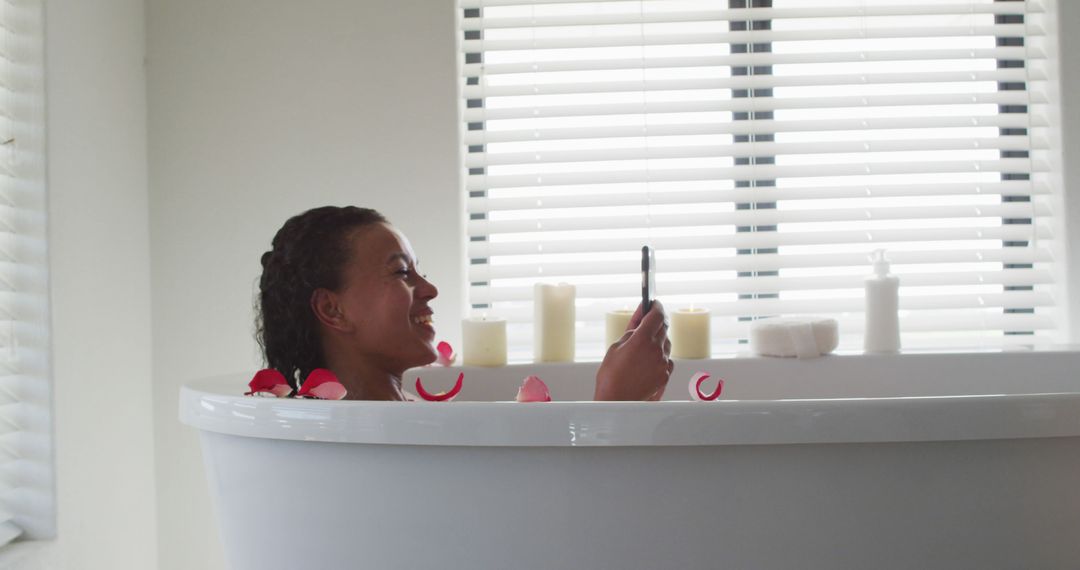 Woman Relaxing in White Bathtub with Candles and Rose Petals - Free Images, Stock Photos and Pictures on Pikwizard.com