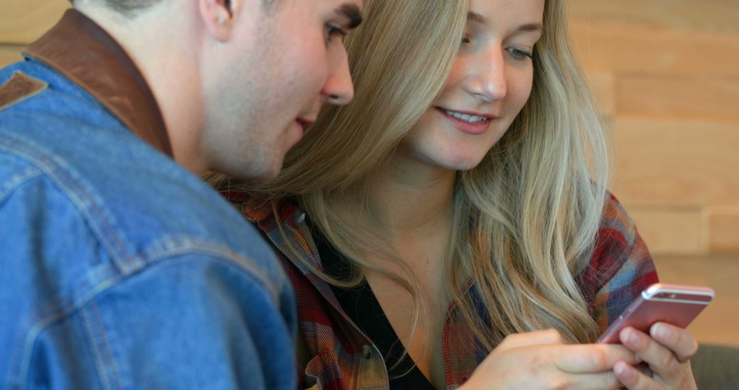 Close-up of young couple using mobile phone in cafe - Free Images, Stock Photos and Pictures on Pikwizard.com