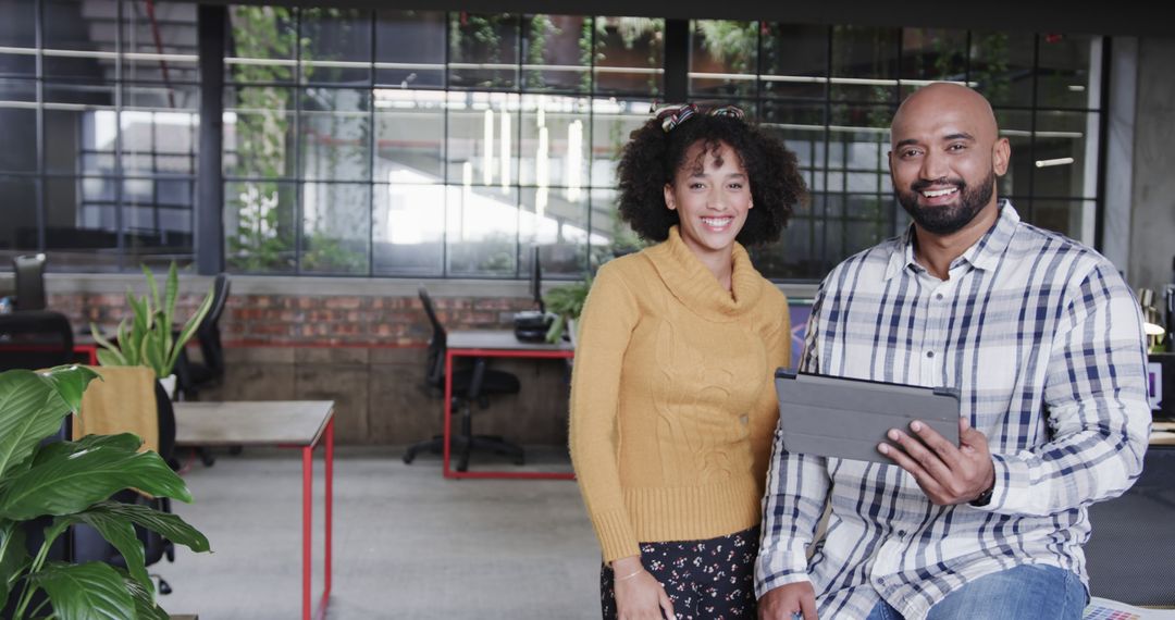 Smiling Business Colleagues Discussing Project with Tablet in Modern Office