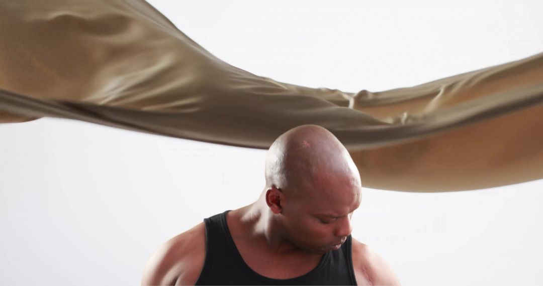 Athletic African American Man Exercising with Dynamic Fabric Motion