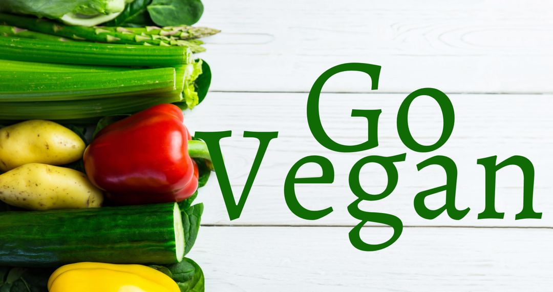 Inspiring Go Vegan Message with Fresh Vegetables Background