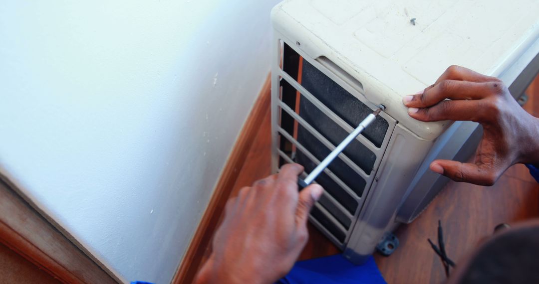 Technician Repairing Broken Air Conditioning Unit - Free Images, Stock Photos and Pictures on Pikwizard.com