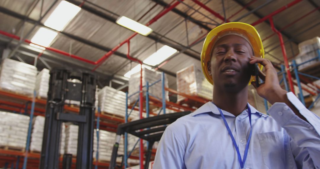 Warehouse Worker Communicating on Phone while Supervising Inventory - Free Images, Stock Photos and Pictures on Pikwizard.com