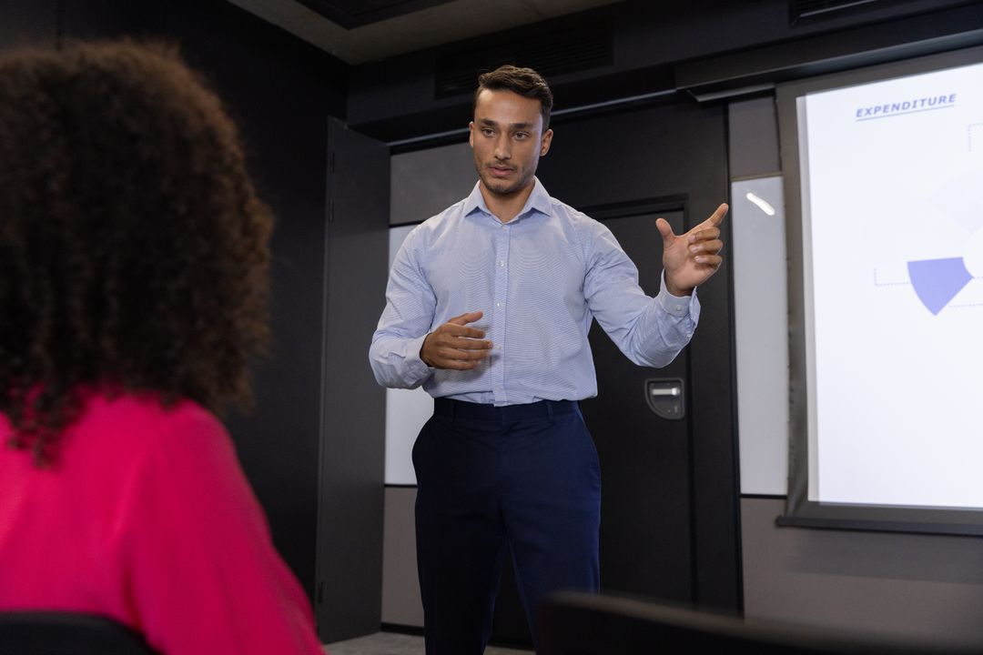 Business Professional Presenting Pie Chart to Colleagues in Formal Meeting