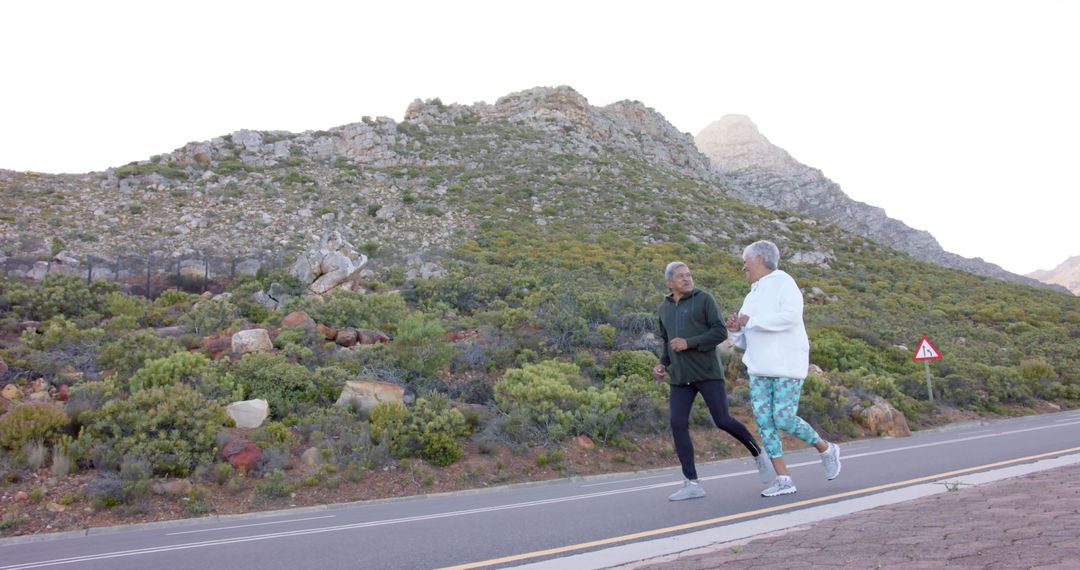 Senior Couple Jogging in Scenic Mountain Landscape - Free Images, Stock Photos and Pictures on Pikwizard.com