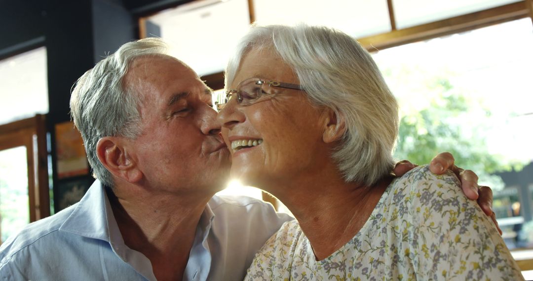 Older Couple Sharing Tender Moment in Sunlit Room - Free Images, Stock Photos and Pictures on Pikwizard.com