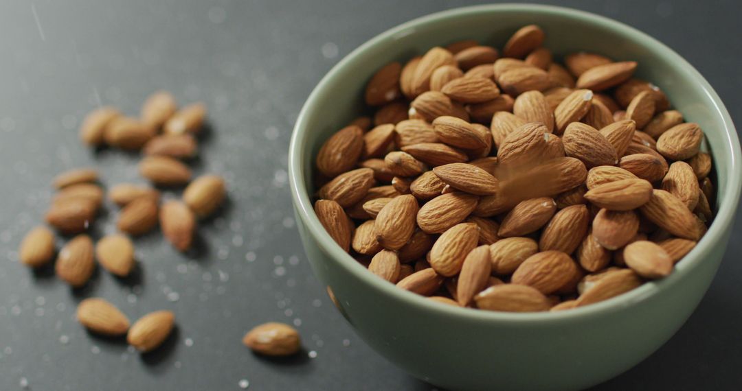 Fresh Almonds in Ceramic Bowl on Gray Surface