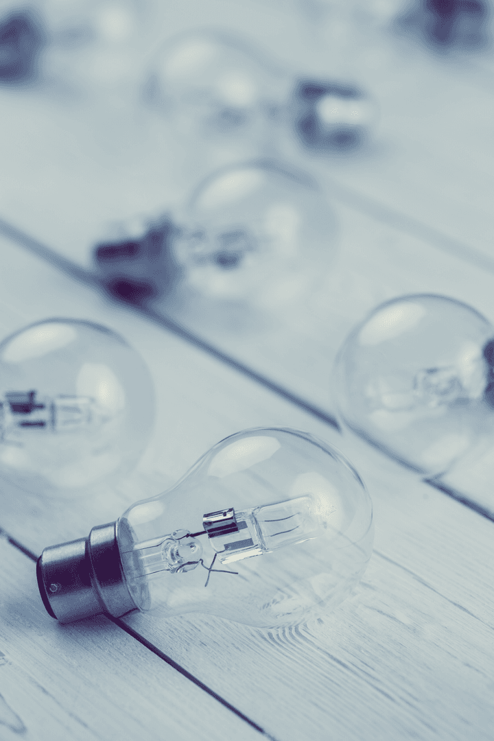 Transparent Light Bulbs on Wooden Floor for Ideas and Knowledge Concept