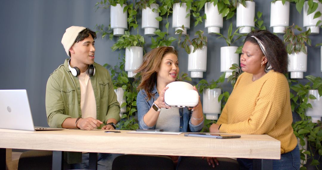 Multicultural Team Examining Prototype Gadget and Brainstorming Features in Green Office