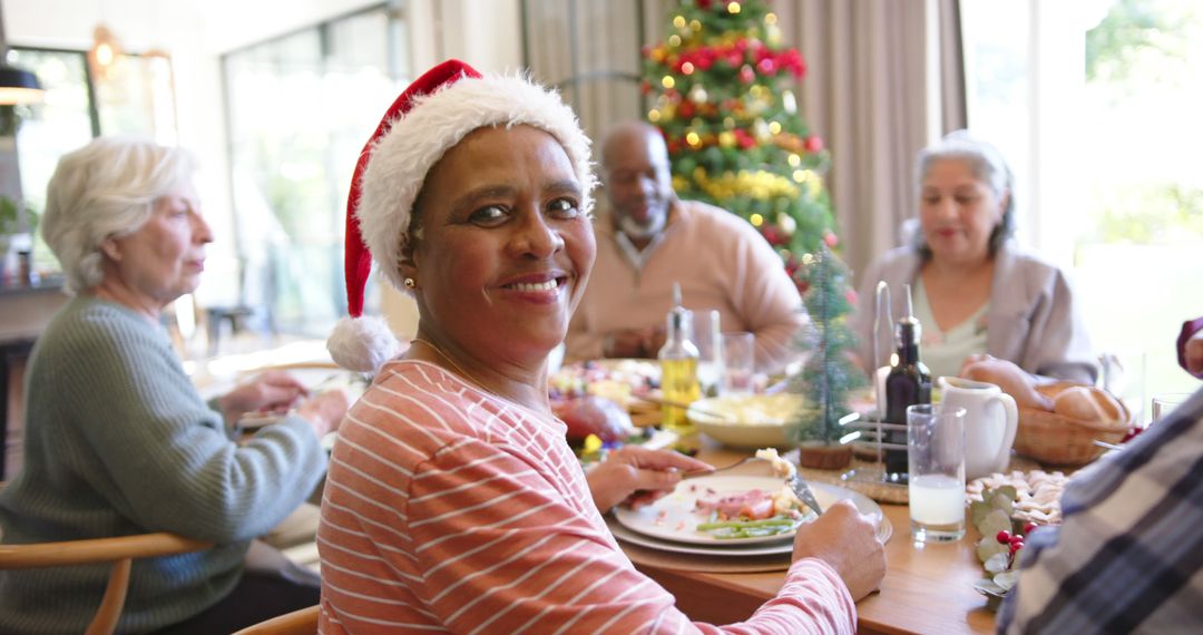 Diverse Group Enjoying Christmas Dinner in Festive Home - Free Images, Stock Photos and Pictures on Pikwizard.com