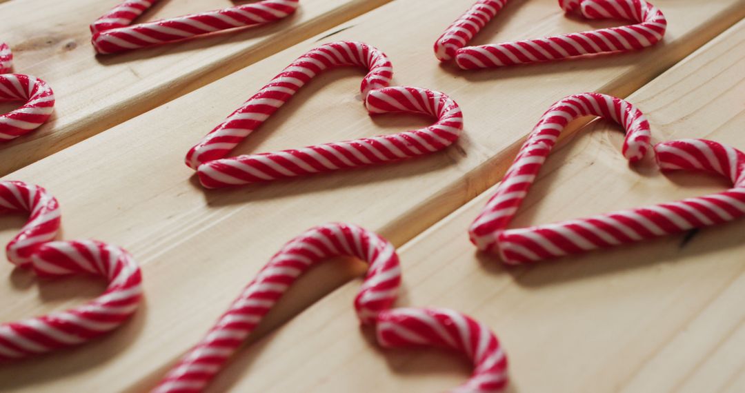 Image of red and white candy canes on wooden background - Free Images, Stock Photos and Pictures on Pikwizard.com