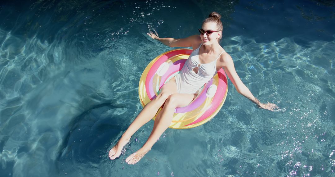 Teen in Sunglasses Relaxing on Inflatable Pool Float