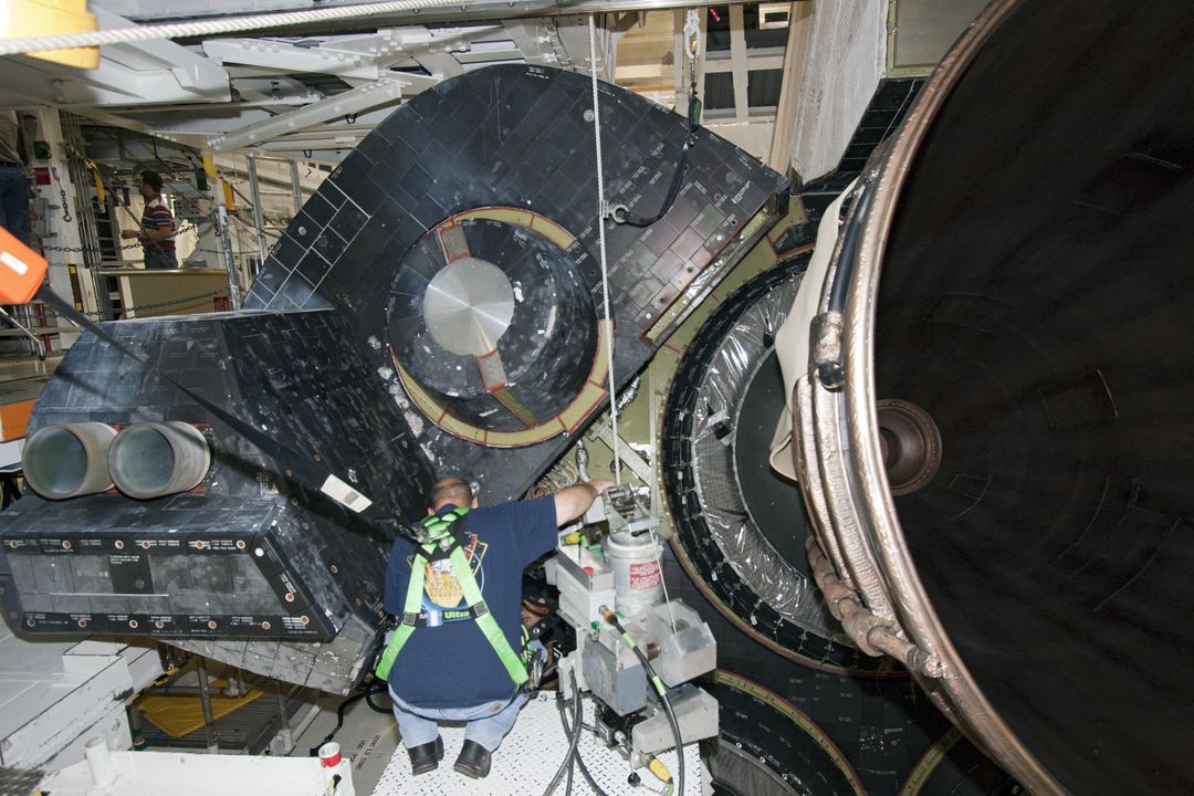 Technicians Installing Heat Shield on Shuttle Endeavour Engine at Kennedy Space Center
