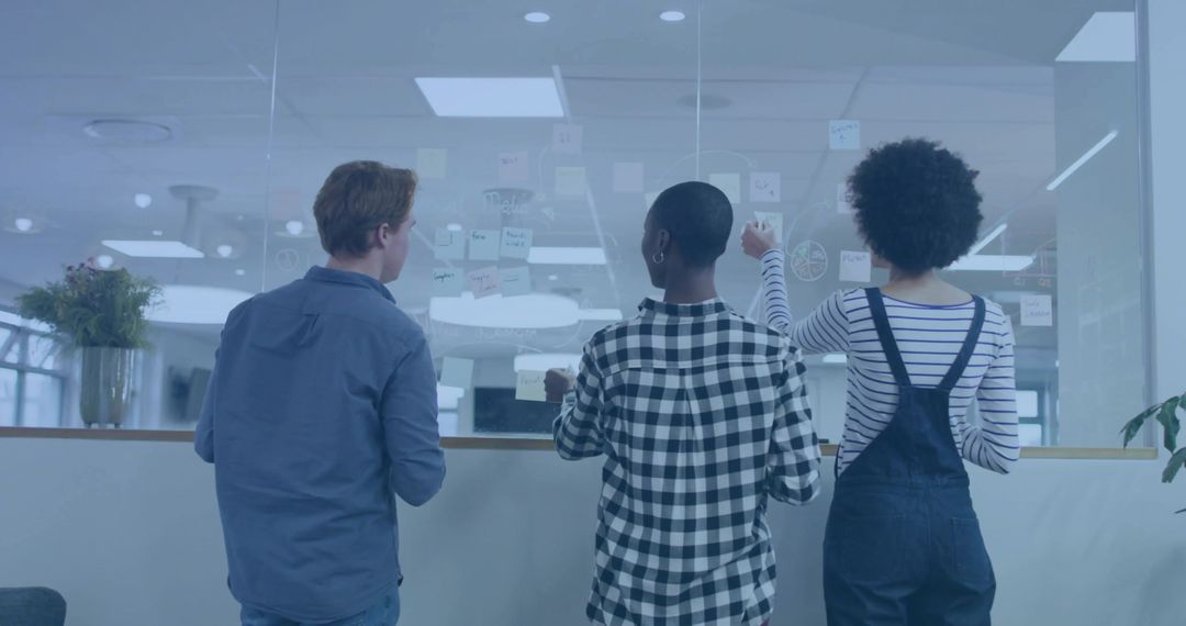 Collaborative Team brainstorming with Sticky Notes in Modern Office