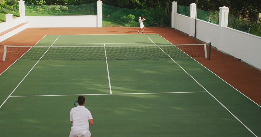 Players Competing in Tennis Match on Outdoor Court - Free Images, Stock Photos and Pictures on Pikwizard.com