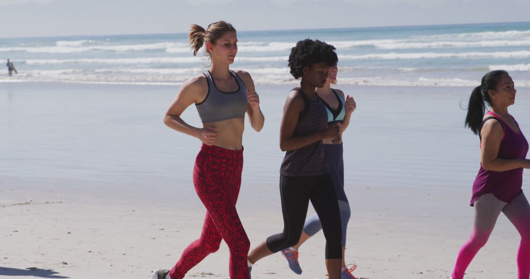 Group Of Women Jogging On Beach - Free Images, Stock Photos and Pictures on Pikwizard.com