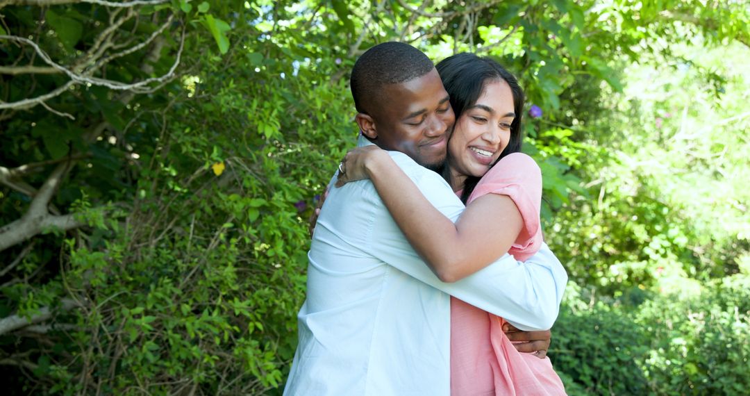 Happy Multiracial Couple Embracing in Sunny Garden