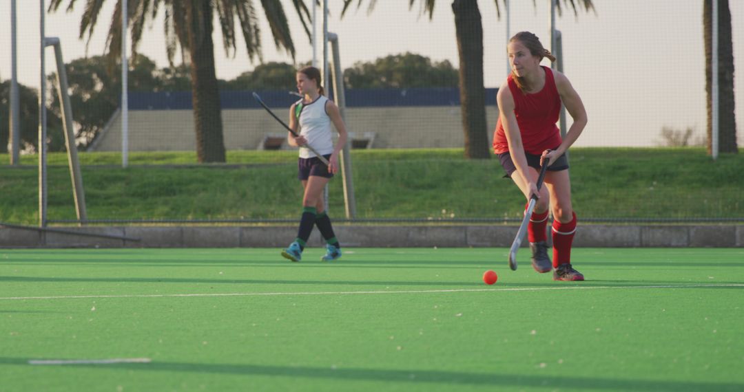 Girls Playing Field Hockey on Green Turf in Sunny Weather - Free Images, Stock Photos and Pictures on Pikwizard.com