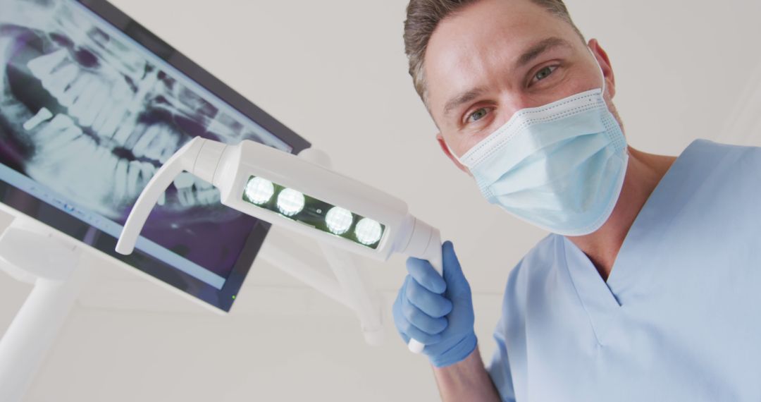 Dentist Examining Patient's Mouth with X-ray on Screen - Free Images, Stock Photos and Pictures on Pikwizard.com