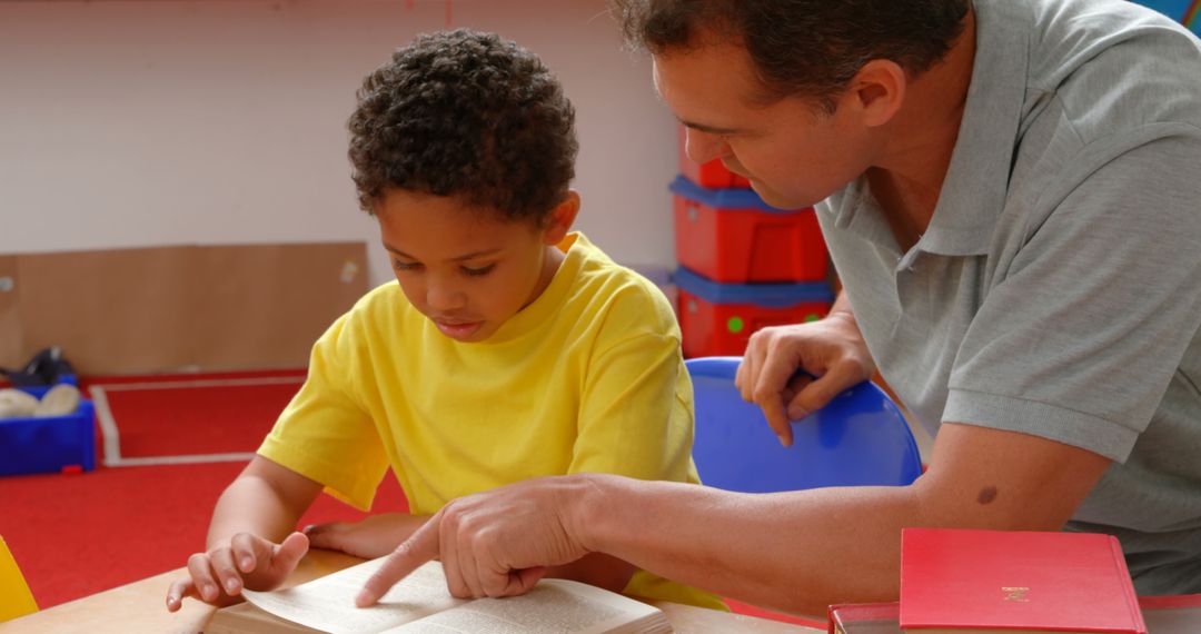 Teacher Guiding Young Student in Reading Activity