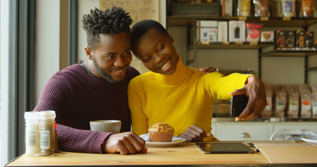 Happy Couple Taking Selfie While Enjoying Coffee and Muffin in Cafe - Free Images, Stock Photos and Pictures on Pikwizard.com