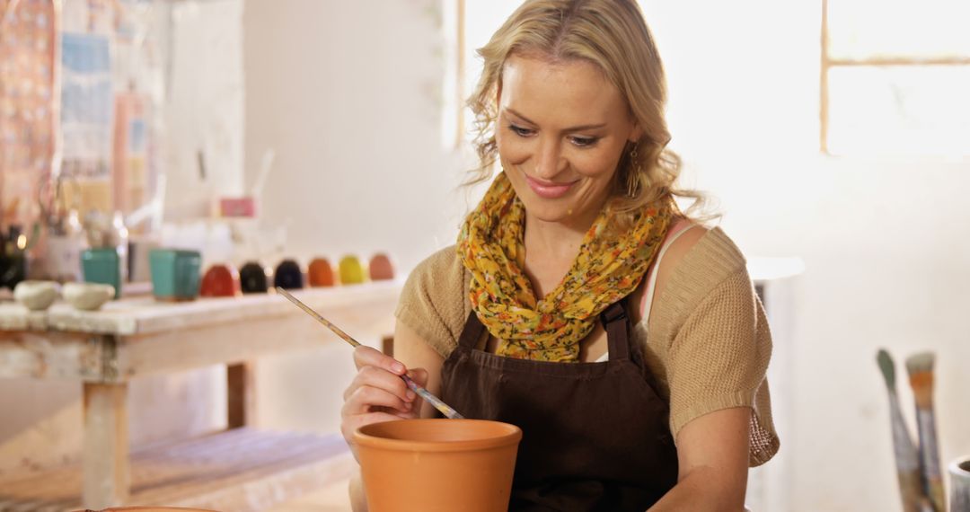 Smiling Woman Painting Pottery in Art Studio - Free Images, Stock Photos and Pictures on Pikwizard.com