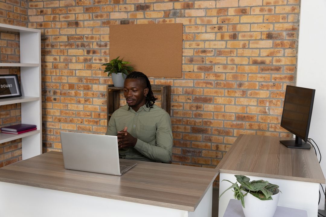 Professional Man in Home Office Using Laptop